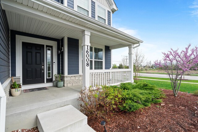 doorway to property with a porch