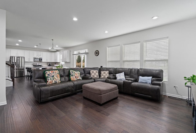 living room featuring recessed lighting, dark wood-style flooring, and baseboards