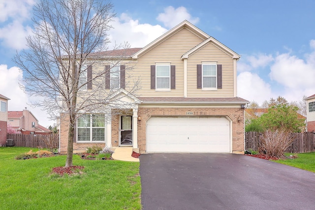 1898 Barrington Ave, Bolingbrook, IL 60490 - traditional-style home with aphalt driveway, an attached garage, fence, a front lawn, and brick siding
