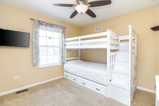 unfurnished bedroom featuring ceiling fan, light colored carpet, visible vents, and baseboards