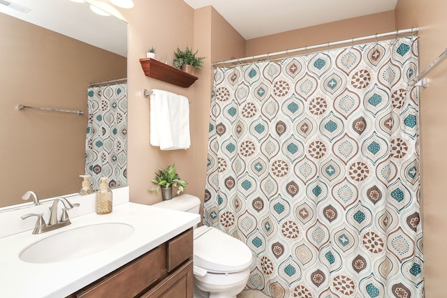 full bath with visible vents, vanity, and toilet