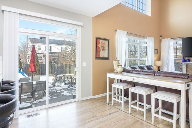 kitchen featuring open floor plan, visible vents, plenty of natural light, and light wood-style flooring