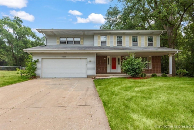 view of front of property featuring a garage and a front lawn