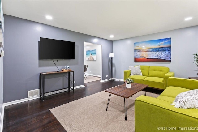 living room featuring dark wood-type flooring