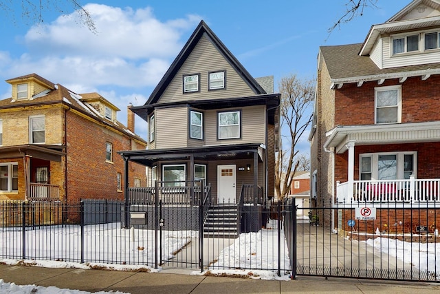 traditional style home with a fenced front yard, a gate, and a porch