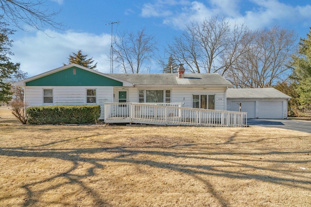 single story home featuring a deck, a front yard, and a chimney