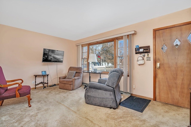 sitting room featuring carpet floors and baseboards