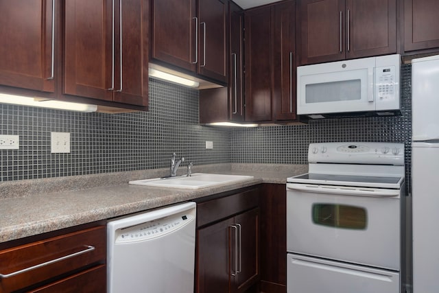 kitchen with white appliances, a sink, backsplash, and dark brown cabinetry