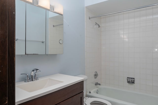 bathroom featuring toilet, vanity, and bathing tub / shower combination