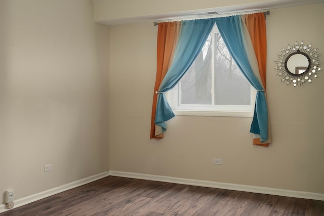 unfurnished room with a healthy amount of sunlight, baseboards, and visible vents