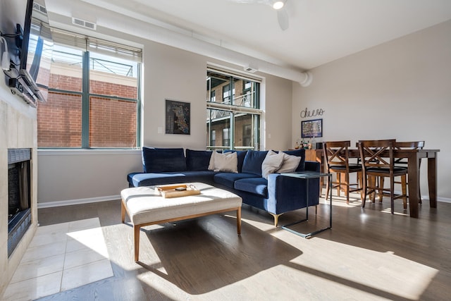 living room featuring plenty of natural light, ceiling fan, and hardwood / wood-style flooring