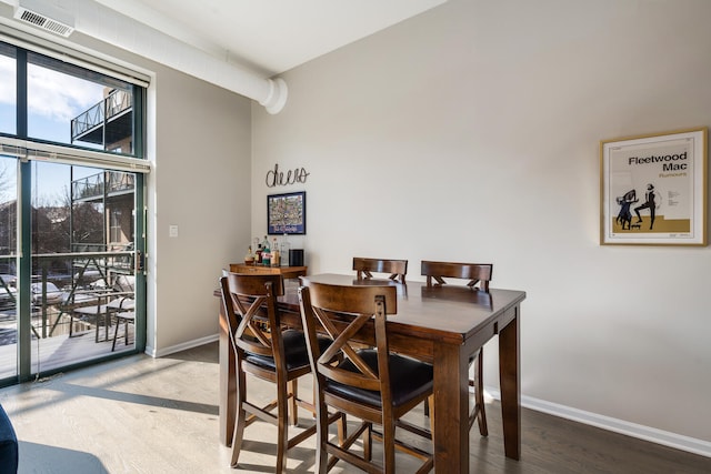 dining space featuring wood-type flooring