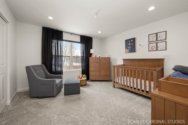 carpeted bedroom with a nursery area