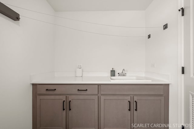 bathroom with vanity and vaulted ceiling