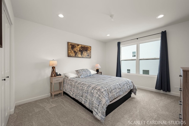 bedroom with light colored carpet and a closet
