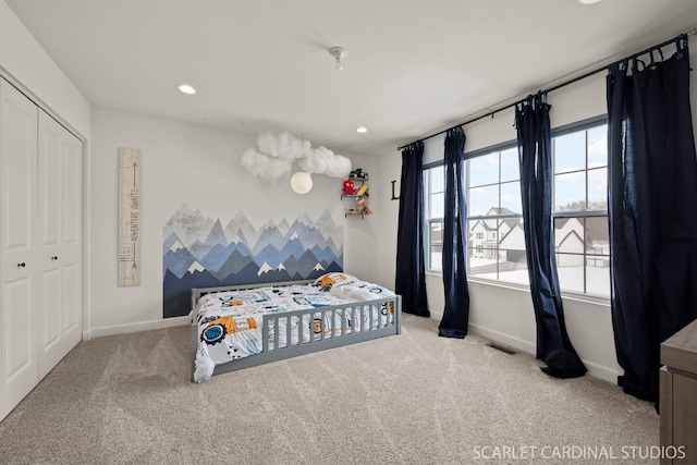 carpeted bedroom with a closet