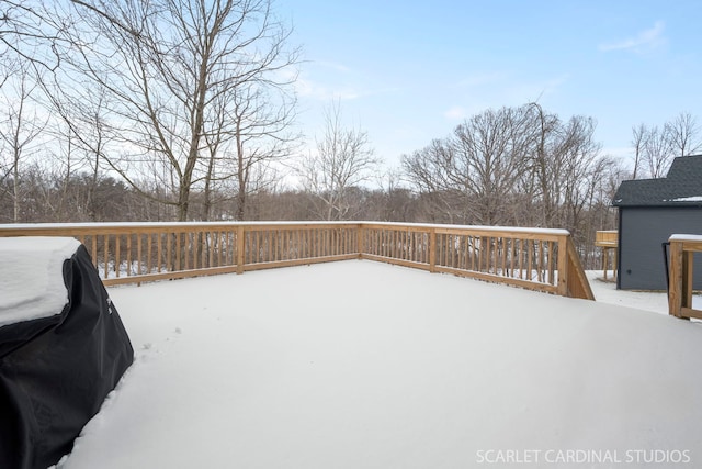 snow covered deck featuring a grill