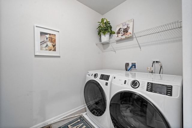 clothes washing area with washer and clothes dryer