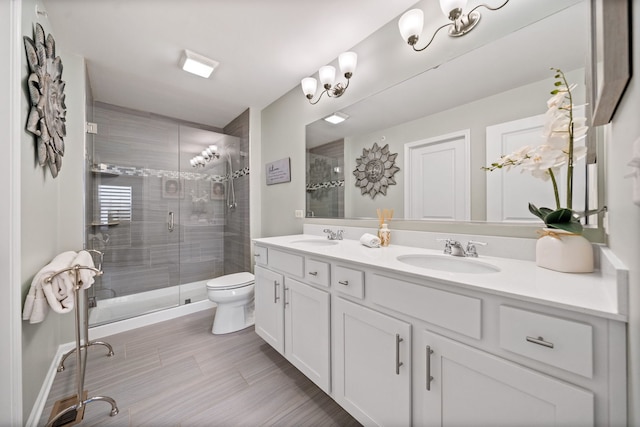 bathroom featuring vanity, toilet, and walk in shower