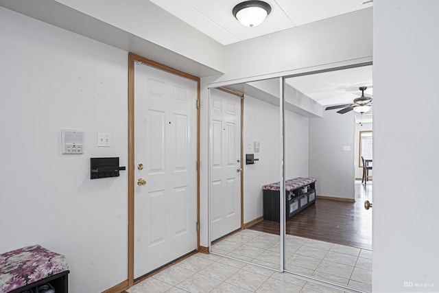 tiled entryway with ceiling fan