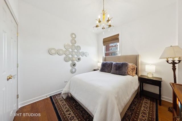 bedroom with an inviting chandelier and hardwood / wood-style flooring