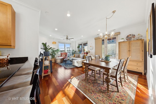 dining space featuring hardwood / wood-style flooring, crown molding, and a notable chandelier