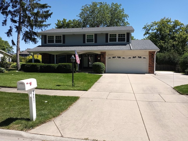 front of property with a front yard and a garage