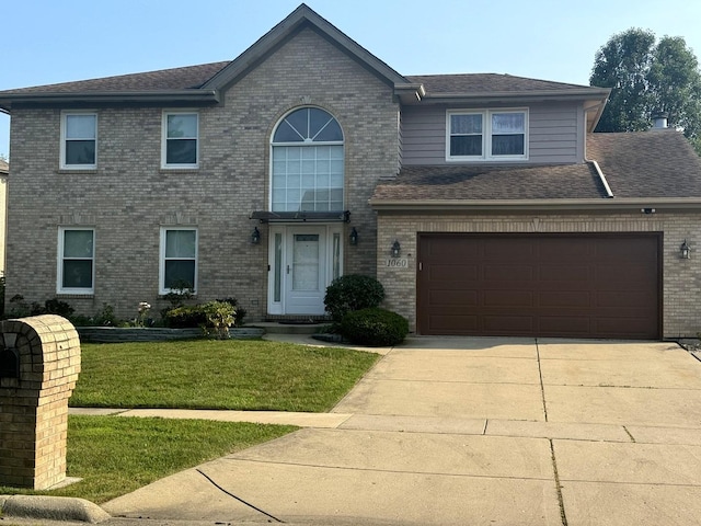 view of front facade featuring brick siding, concrete driveway, a front lawn, and a shingled roof