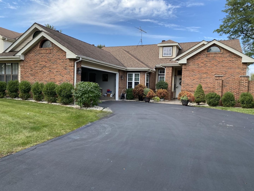 view of front of house with a garage and a front lawn