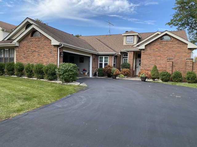 view of front of house with a garage and a front lawn