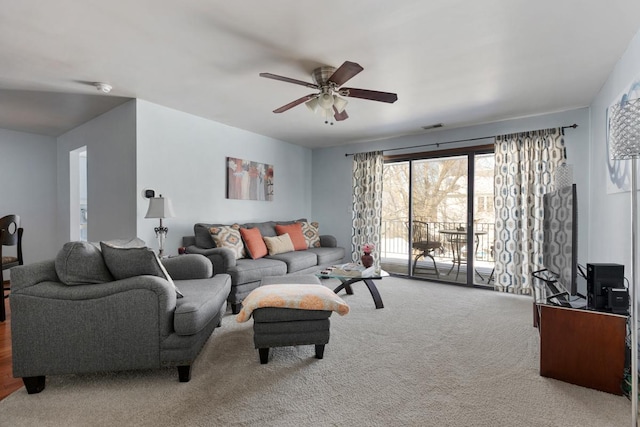 carpeted living room with ceiling fan and visible vents