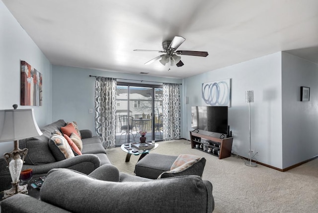 living area featuring light colored carpet, ceiling fan, and baseboards