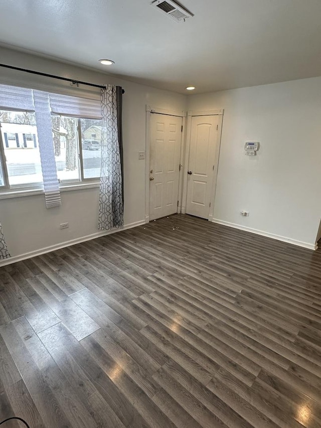 unfurnished room with dark hardwood / wood-style flooring