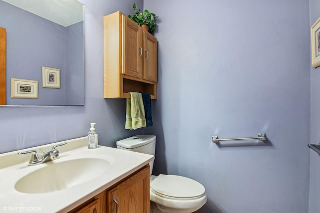 bathroom with toilet and vanity