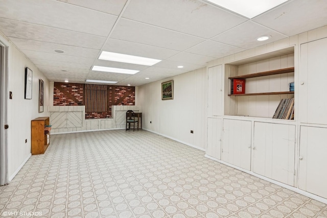 finished basement with recessed lighting, a paneled ceiling, and baseboards