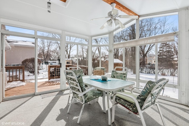 sunroom with beam ceiling and ceiling fan