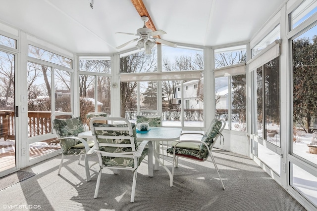 sunroom with beamed ceiling, a healthy amount of sunlight, and ceiling fan