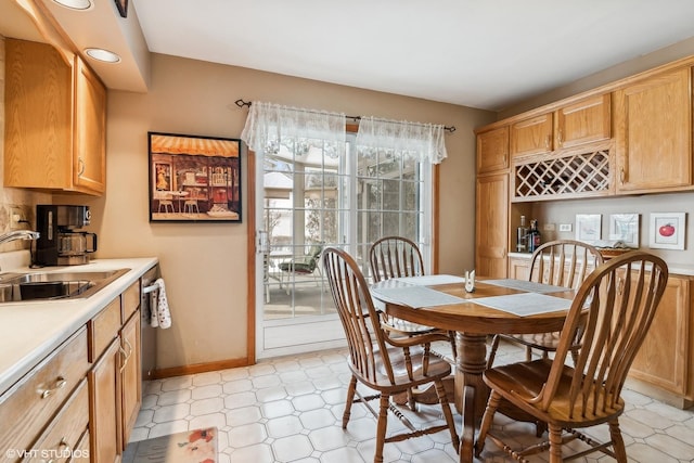 dining room featuring baseboards and light floors