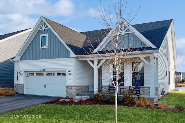 view of front of home with board and batten siding, a shingled roof, aphalt driveway, a porch, and an attached garage