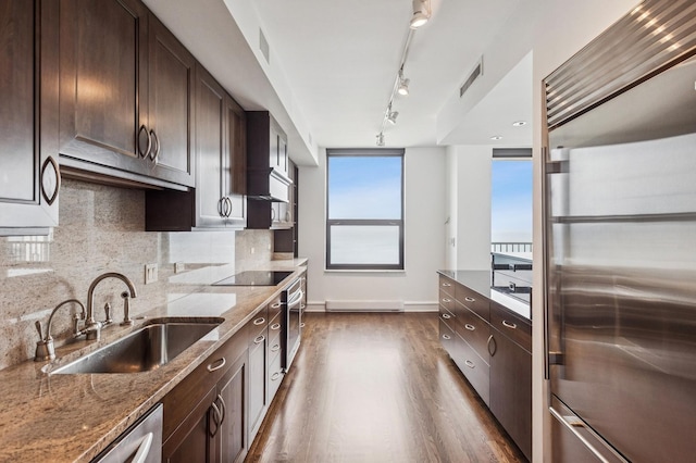 1040 N Lake Shore Dr Unit 34C, Chicago, IL 60611 - kitchen with stainless steel appliances, track lighting, dark wood-type flooring, and dark brown cabinetry