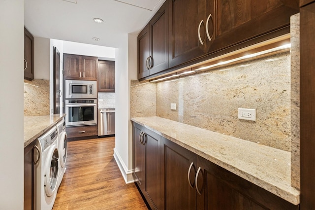 1040 N Lake Shore Dr Unit 34C, Chicago, IL 60611 - kitchen with stainless steel appliances, washer / dryer, light wood-type flooring, backsplash, and dark brown cabinets