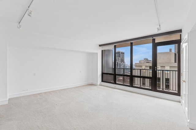 1040 N Lake Shore Dr Unit 34C, Chicago, IL 60611 - carpeted spare room featuring rail lighting and baseboards