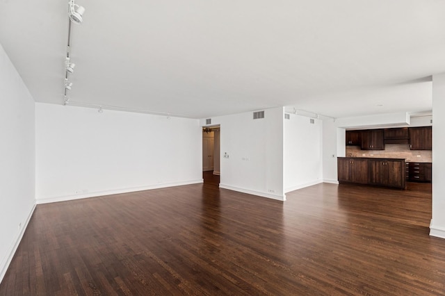1040 N Lake Shore Dr Unit 34C, Chicago, IL 60611 - unfurnished living room featuring track lighting and dark wood-style flooring