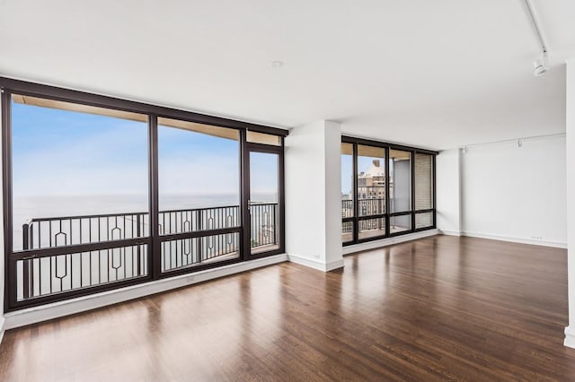 1040 N Lake Shore Dr Unit 34C, Chicago, IL 60611 - unfurnished room featuring wood finished floors and rail lighting