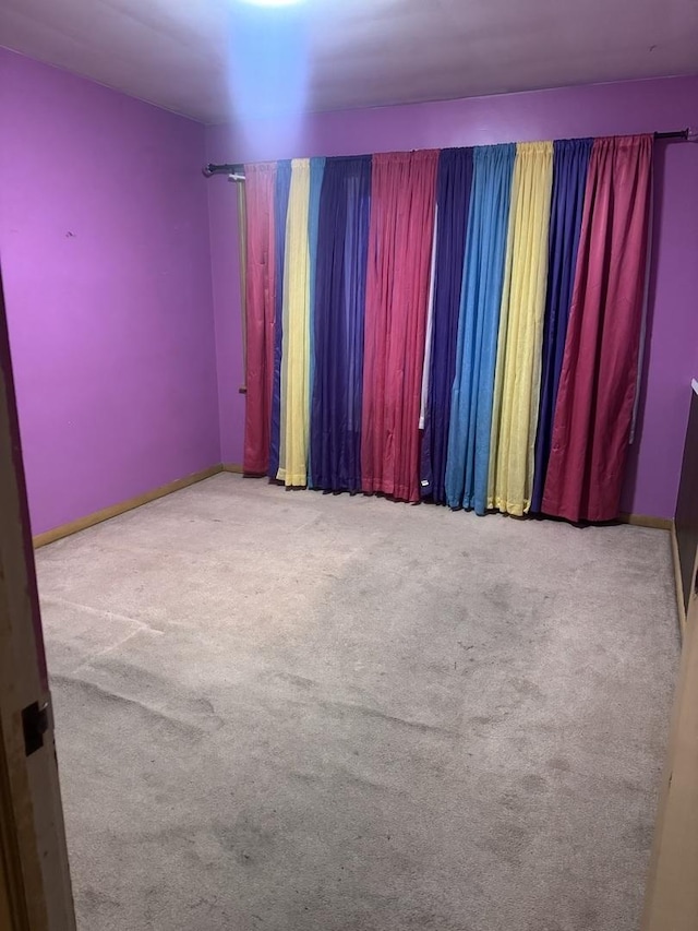 empty room featuring light colored carpet