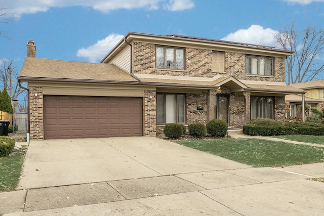 view of front of property featuring a garage and a front lawn