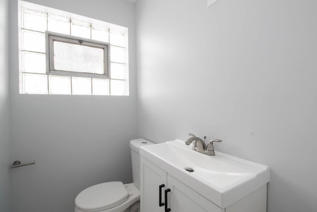 bathroom featuring toilet and vanity