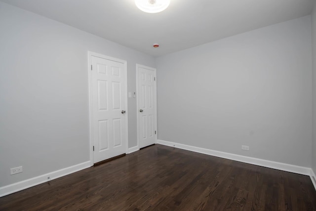 spare room with dark hardwood / wood-style flooring