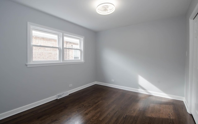 unfurnished room featuring dark wood-type flooring