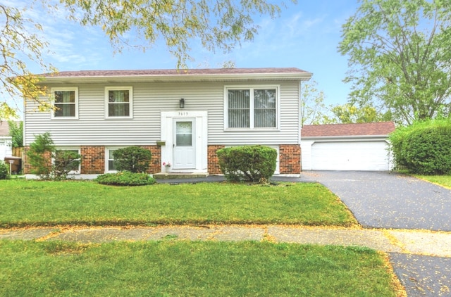 split foyer home with a garage and a front lawn